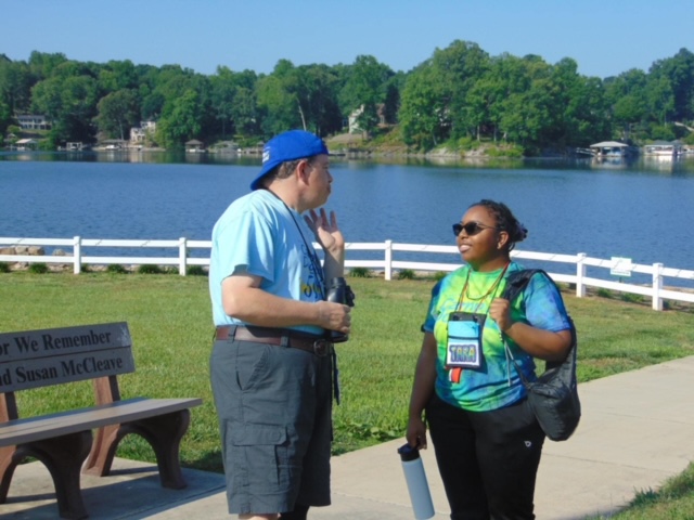 A counselor and camper enjoying the waterfront together.